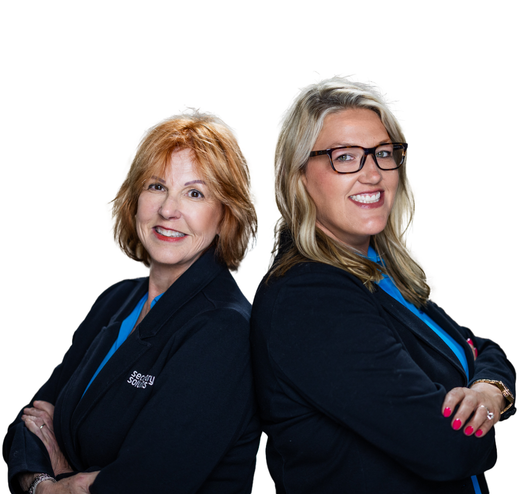 Mindy and Tina Stevens, arms crossed, looking confidently outwards