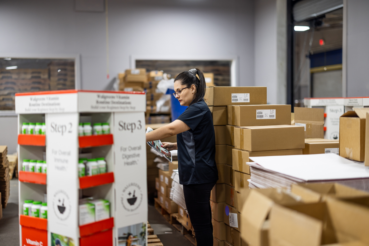 Secondary Solutions female team member double-checking POP display for quality