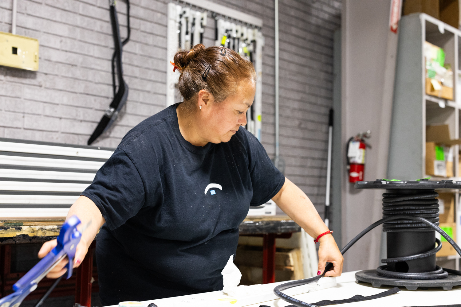 Secondary Solutions female team member working with wiring